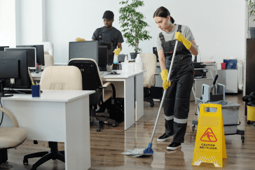 Here's an alt tag for the image: > Office cleaners mopping and disinfecting.