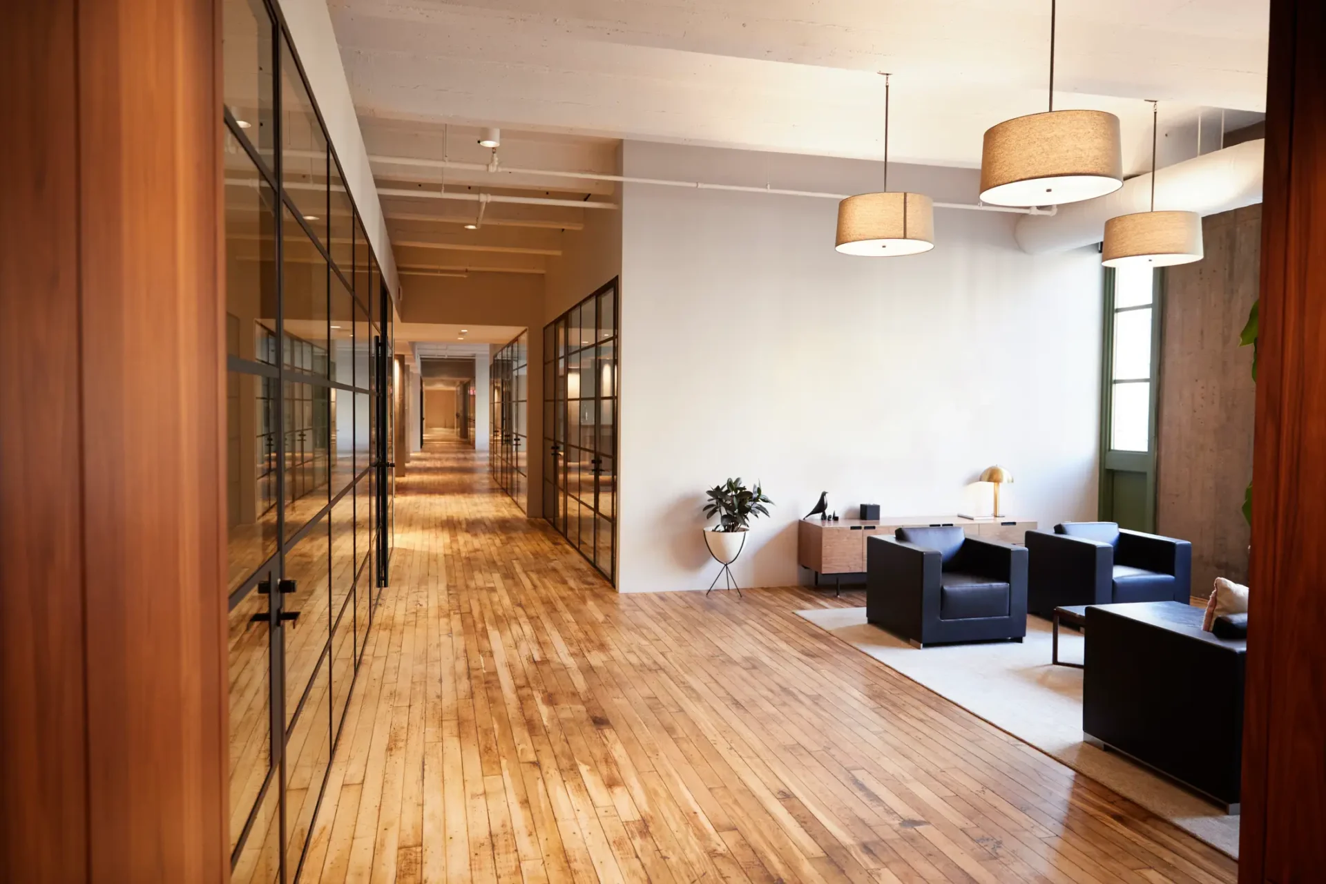 Modern office hallway with wood floors.